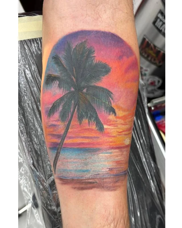 Heather Baldwin realism Hawaiian palm tree sunset tattoo on calf